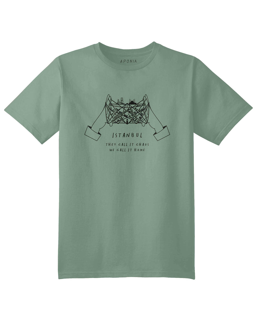 A green t shirt with a graphic of cat's cradle with Istanbul attractions on the thread and slogan of "they call it chaos, we call it home"